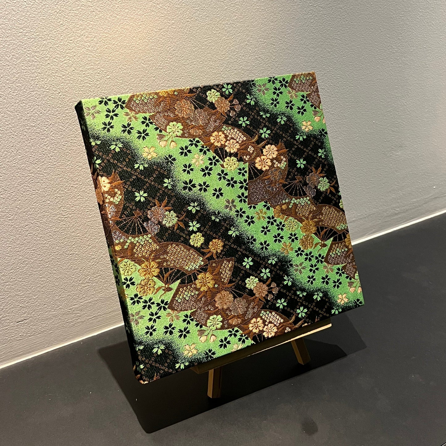 Nishijin woven fabric board with Japanese flowers and fan patterns standing out against the green space(011-FB)